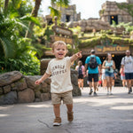 Load image into Gallery viewer, Child wearing a &#39;Jungle Skipper&#39; shirt pointing at an attraction in a theme park.
